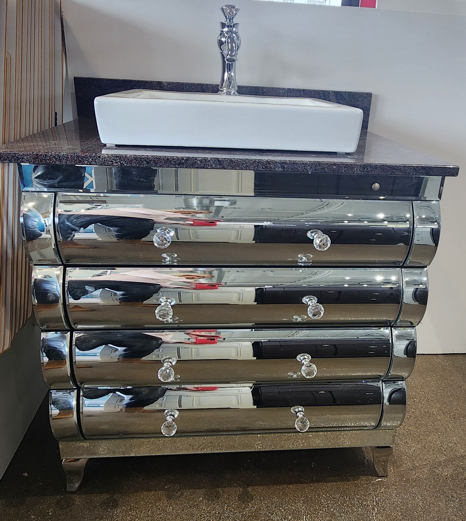 Mirrored cabinet with granite top and vessel sink